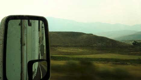 A-dirty-looking-landscape-as-shown-through-a-passing-RV