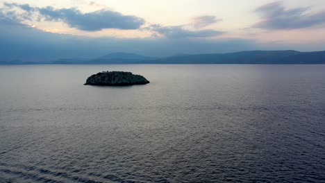 A-small-island-in-front-of-Vlychos-Plakes-Beach-in-Hydra-Island,-Greece