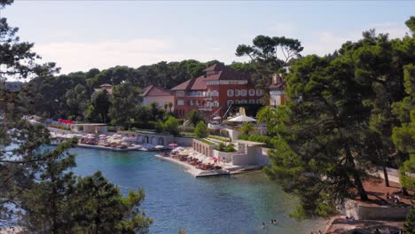 Slow-aerial-of-a-beautiful-resort-with-umbrellas-in-the-island-of-Losinj