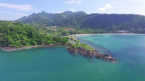 Idyllic-Koh-Chang-island-aerial-pull-back-view-across-turquoise-coastal-ocean-bay-resort