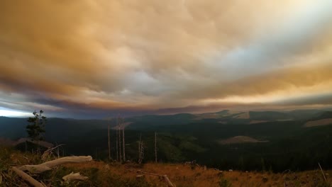 Smokey-orange-wildfire-time-lapse-at-sunset-from-mountain-peak
