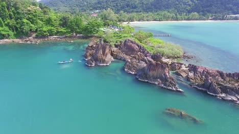 Idyllic-Koh-Chang-island-aerial-push-in-view-towards-turquoise-coastal-ocean-bay-resort-buildings-Thailand