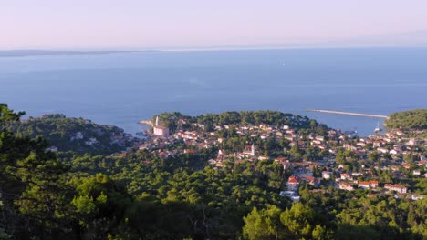 Beautiful-aerial-view-of-the-city-of-Mali-Losinj-surrounded-by-forest-in-the-coast-of-Croatia