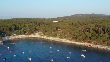 Aerial-dolly-shot-of-a-bay-full-of-anchored-boats-in-Mali-Losinj,-Croatia-on-a-bright-day
