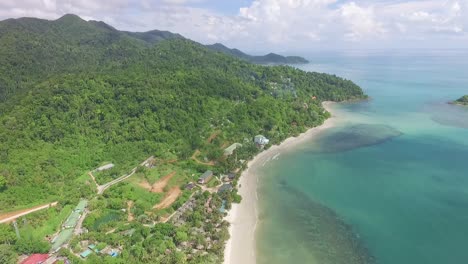 Slow-rising-aerial-view-above-Thailand-Koh-Chang-island-colourful-scenic-resort-coastline