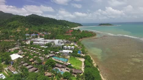 Aerial-view-descending-to-tropical-Koh-Chang-island-paradise-vacation-coastline-resort