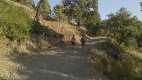 Man-and-woman-walking-on-at-path-in-the-mountains