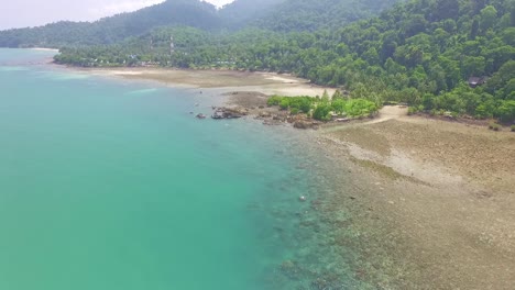 Aerial-tracking-shot-of-tropical-Island-,-jungle-and-coral-reef