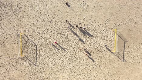 AERIAL:-Two-Teams-Plays-Football-on-a-Sandy-Beach-on-Beautiful-Summer-Day