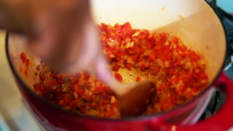 Sauteing-red-peppers-and-onions-in-a-pot-for-a-special-soup-recipe---slow-motion