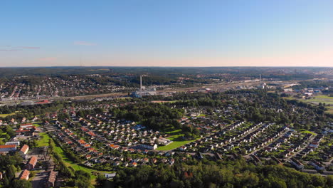Aerial-drone-view-of-suburbs-area-in-east-Gothenburg,-Sweden,-sunset,-lowering