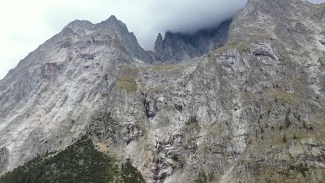 Stunning-4k-drone-footage-panning-across-the-high-mountain-peaks-revealing-a-glacier-and-water-falls-on-the-Italian-side-of-the-Mont-Blanc-Massive