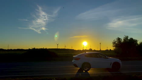 Cars-Driving-Through-A-Highway-Overlooking-Beautiful-Sunrise-In-Clear-Morning-Sky-Of-Koleczkowo-Poland---wide-shot