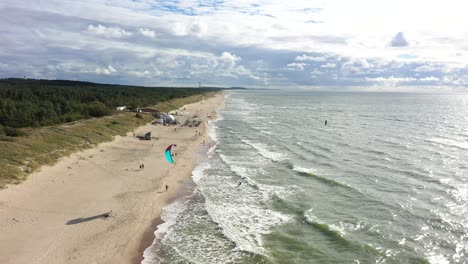 AERIAL:-Surfer-Rides-Waves-on-a-Sunny-Day-in-Baltic-Sea-near-Coast