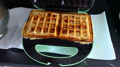 Lifting-Top-to-Reveal-Cooked-Cheese-Jaffle-Waffle-Toasties-Slow-motion---High-Frame-Rate
