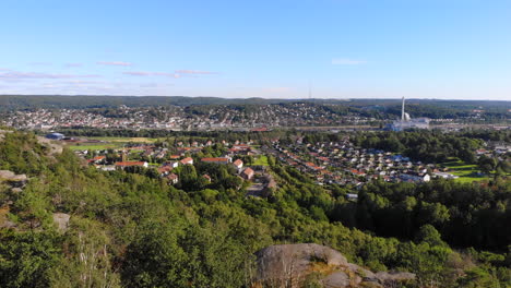 Aerial-drone-flying-up-above-trees-in-east-Gotheburg-revealing-peaceful-suburbs-area,-Sweden,-day