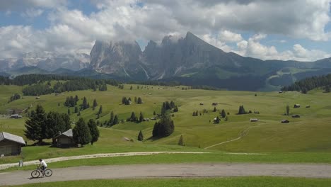 One-guy-cycles-through-the-Mountains-Ranges-of-the-Seiser-Alm-Italian-Alps,-Urtisei,-Urtijei,-Alpe-di-Siusi,Italy,-Europe