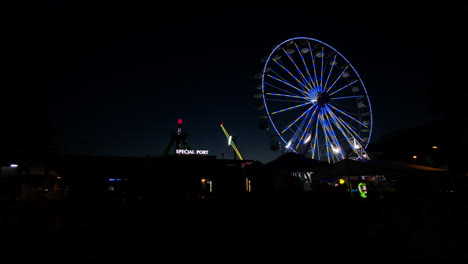 Colorful-Ferris-Wheel-Against-The-Night-Sky-At-The-Amusement-Park-In-Poland---wide-shot