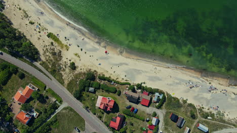 The-Wonderful-Skyview-In-Byxelkrok,-Öland,-Sweden-With-Clear-Green-Ocean-Surrounding-The-Village---Aerial-Shot