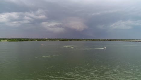 Aerial-video-of-boats-driving-on-Lake-Lewisville-in-Texas-with-an-incoming-storm
