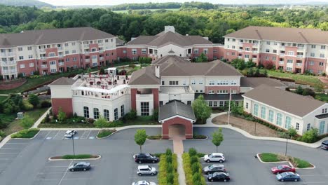Descending-aerial-on-retirement-home-community,-assisted-living,-senior-citizen-home,-large-CCRC-complex-for-continuing-care,-United-States-of-America,-USA-Baby-Boomer-generation,-healthcare-facility