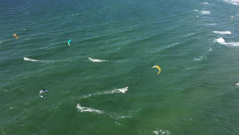 AERIAL:-Rotaing-Shot-of-Surfers-Riding-Waves-on-a-Windy-Day-in-Lithuania