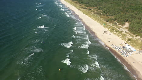 AERIAL:-Rotating-Shot-of-Waves-Crashing-on-a-Beach-From-Very-High-Altitude