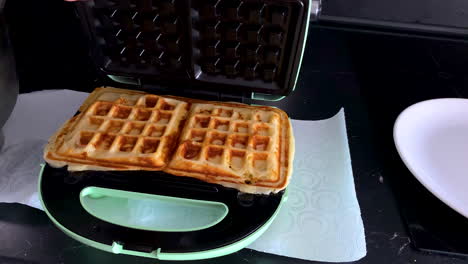 Opening-An-Electric-Waffle-Maker-With-Hot-Belgian-Waffles-Cooked-Inside---close-up,-slow-motion