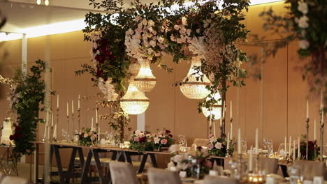 Wedding-reception-tables-with-chandelier-and-hanging-flower-decor