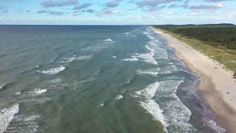 AERIAL:-Flying-Over-Majestic-Blue-Colour-Baltic-Sea-with-Crashing-Waves-on-Windy-Day