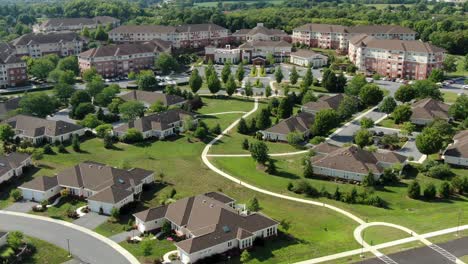 Pullback-rising-aerial-reveals-large-retirement-home-community,-senior-living,-USA-America-55-plus-community-for-retirees,-healthcare,-nursing-care,-assisted-living,-independent-aging-at-home