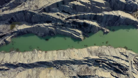 Top-down-view-of-a-quarry-construction-site-with-beautiful-color-contrasts