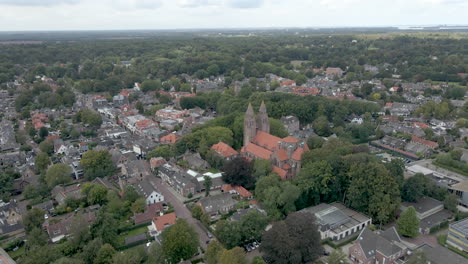 Beautiful-aerial-of-small-dutch-town-with-a-large-church-in-the-town-center
