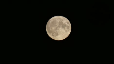 Full-harvest-moon-crater-surface-closeup-passing-across-dark-Halloween-sky