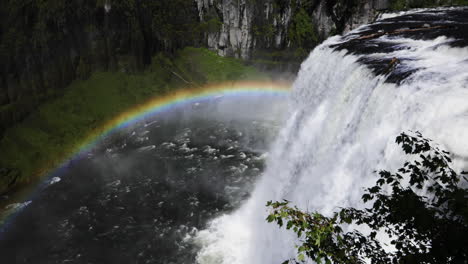 Still-shot-of-beautiful-rainbow-over-the-Upper-Mesa-Falls-in-Idaho,-USA