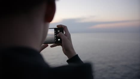 Taking-photos-of-sunrise-with-Smartphone-on-ferry-to-Norway-in-slow-motion