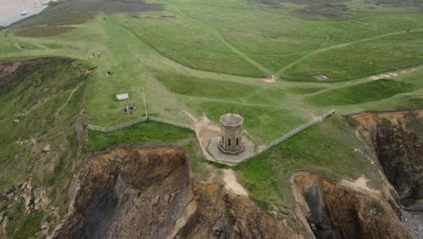 Bude-,Cornwall-UK-Compass-point-small-tower-overlooking-the-sea-Drone-high-Point-of-view