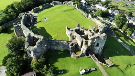 Historic-British-landmark-Denbigh-Castle-medieval-old-hill-monument-ruin-tourist-attraction-aerial-top-down-view