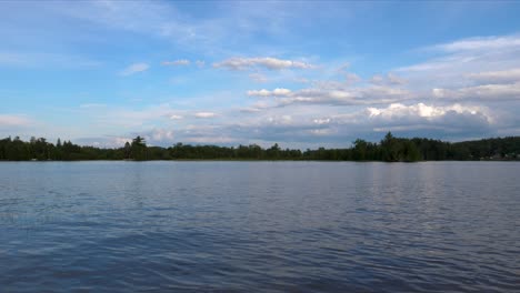Calming-Tranquil-Lake-Water-Rippling-Over-Cotton-Candy-Skies---Water-and-Clouds-in-Ontario-Canada
