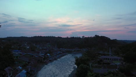 Aerial-view-of-Bahorok-River-and-Bukit-Lawang-village-in-Gunung-Leuser-National-Park,-the-Tropical-Rainforest-Heritage-of-Sumatra,-Indonesia-at-dawn