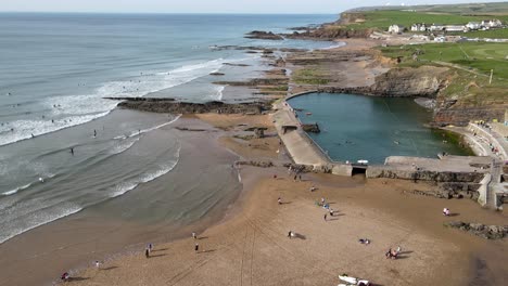 Bude-Sea-Pool-done-flys-over-beach-people-swimming-lifeguards-on-duty