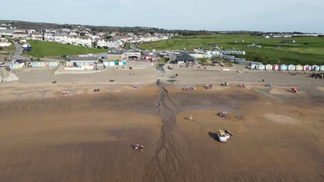 Westward-Ho-Devon-beach-front-aerial-footage-drone-pans-right-to-left-life-guards-on-patrol-very-few-people-on-beach