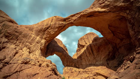 Time-Lapse-of-Natural-Double-Arch-adn-Dramatic-Dynamic-Cloudy-Sky-Above-Natural-Landmark-of-Arches-National-Park,-Utah-USA