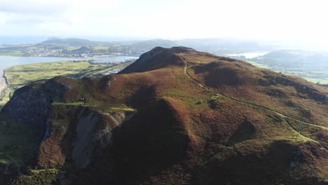 Aerial-view-idyllic-rural-Welsh-mountain-valley-Llandudno-coastline-pan-right