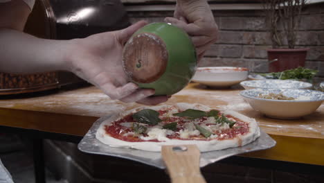 Chef-puts-olive-oil-on-to-of-Neapolitan-pizza-dough