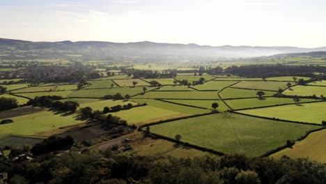 Beautiful-misty-North-Wales-countryside-rural-patchwork-landscape-aerial-view-pan-right