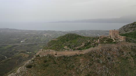 Aerial-drone-panoramic-view-video-of-historic-uphill-medieval-castle-of-Acrocorinth-an-ancient-citadel-overlooking-ancient-Corinth-with-breathtaking-view,-Peloponnese,-Greece