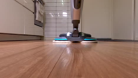 Cleaning-the-kitchen-floorboards-with-a-floor-polisher