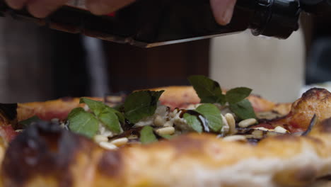 Adding-sauce-to-the-pizza-topping.-Slow-motion