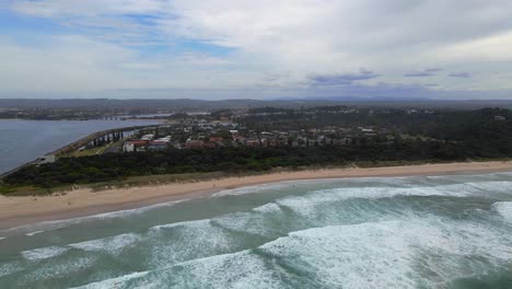 White-Foamy-Waves-Splashing-At-The-Sea-Coast---Sharpes-Beach-In-Skennars-Head---NSW,-Australia---aerial